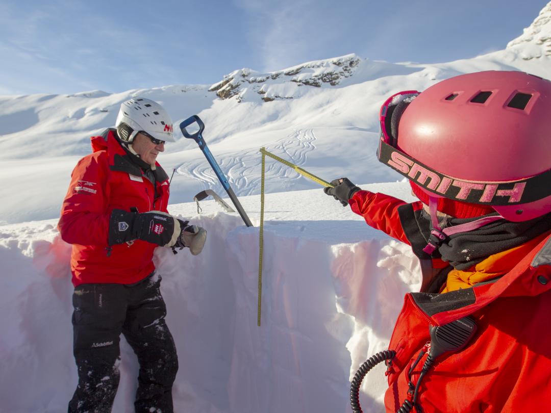 Mike Wiegele & heli-ski guide test a snowpit