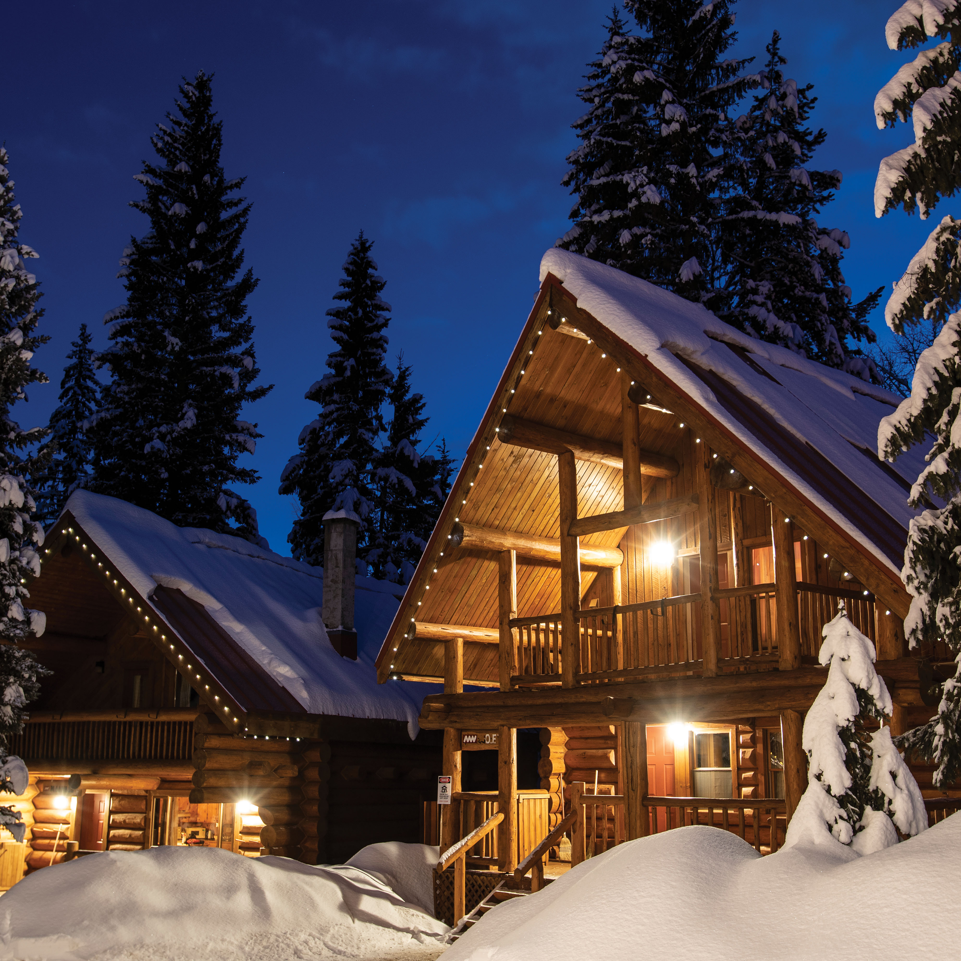 Winter snowy log chalets at Mike Wiegele Heli-ski resort.