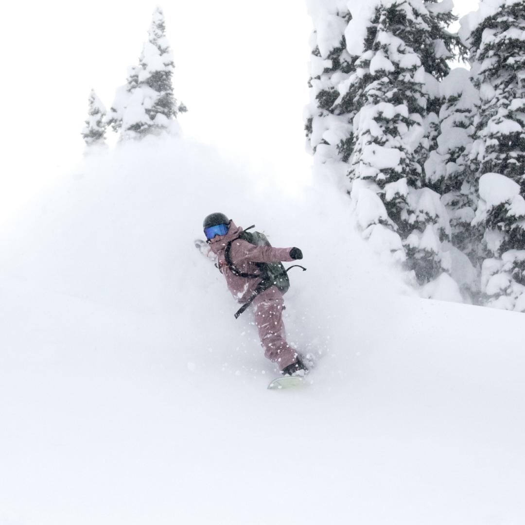 Guest snowboarding deep powder