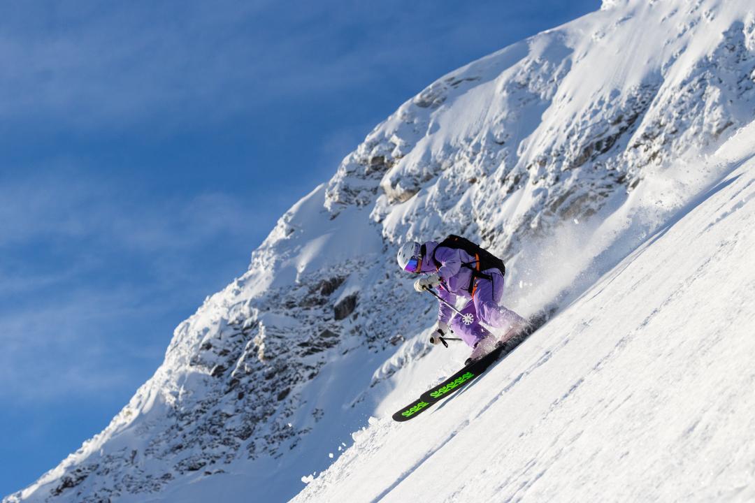 Guest skiing on a blue bird day