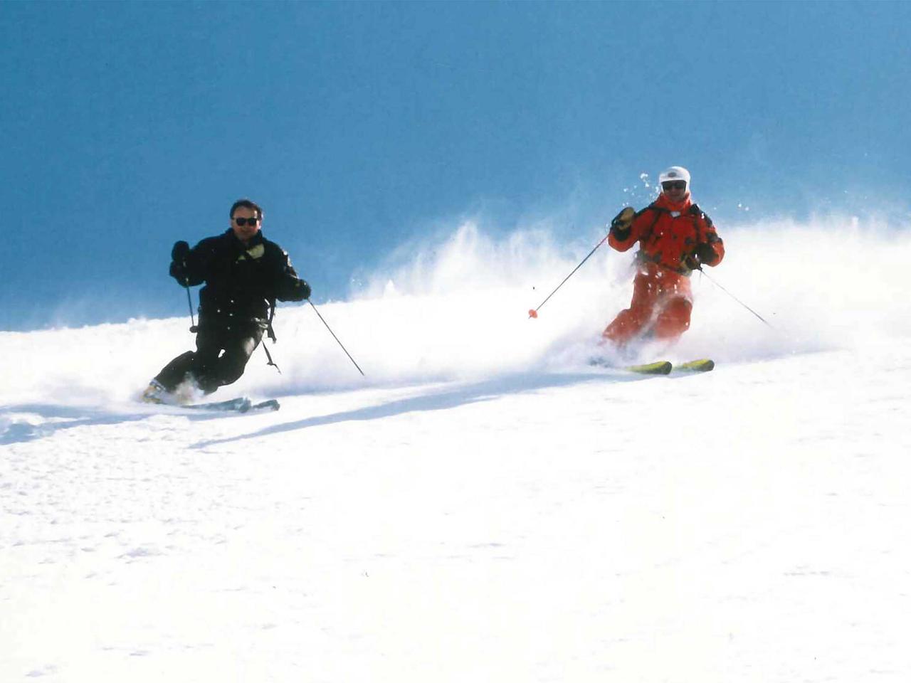 Mike Wiegele and Atomic Rupert Hubert heliskiing over 2 decades ago.